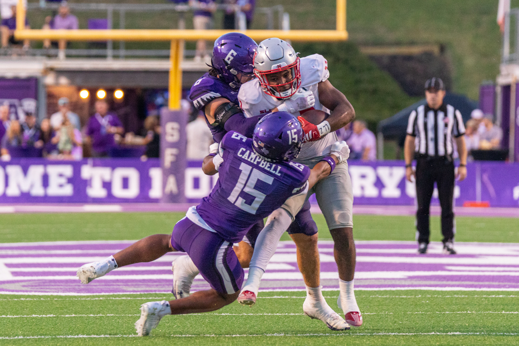 SFA redshirt-senior safety Rayden Campbell and SFA senior linebacker Jaydon Southard bring down Nicholls sophomore running back Miequle Brock Jr.