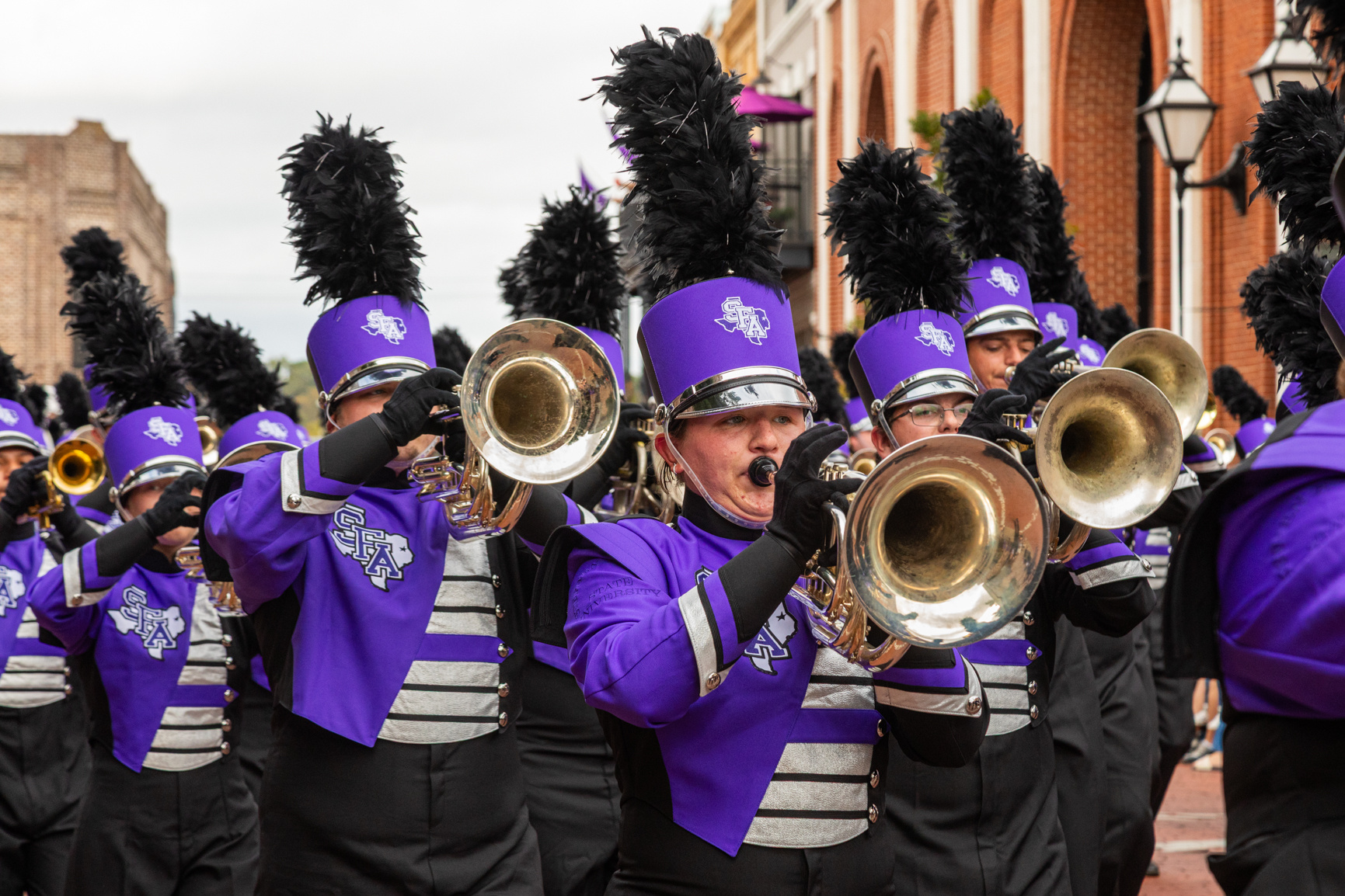 Members of the Lumberjack Marching Band march through downtown Nacogdoches during the annual SFA Homecoming parade.