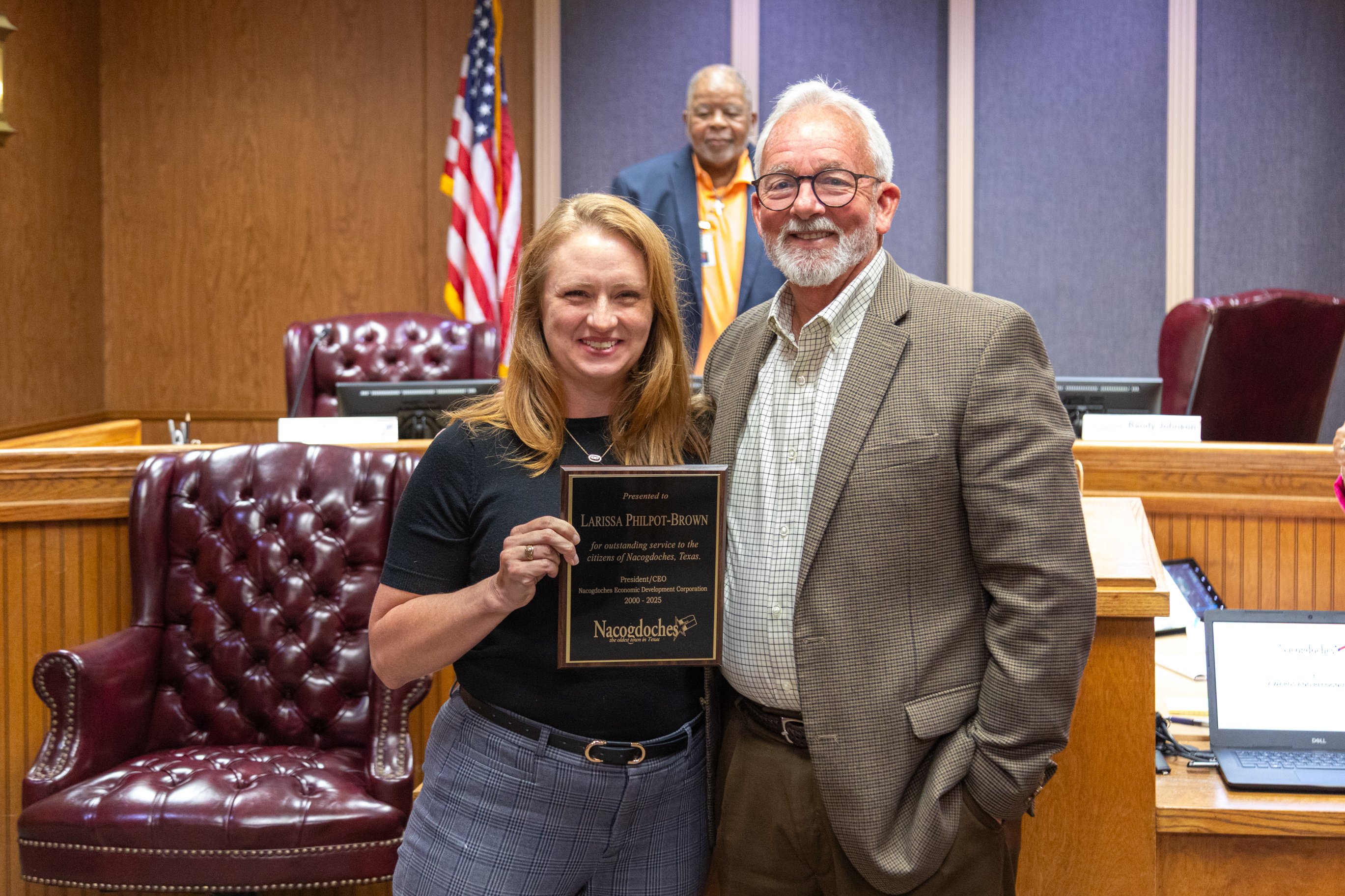 Executive Director of the Nacogdoches Economic Development Corporation, Larissa Philpot-Brown, stands with Nacogdoches Mayor Randy Johnson after being given a plaque for 25 years of service to the city.